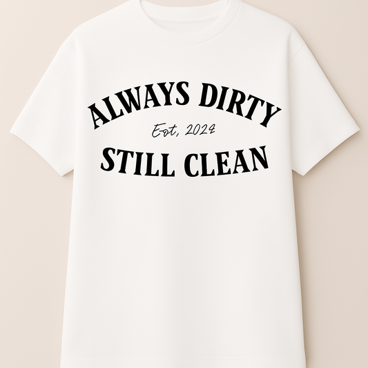 White t-shirt with black text 'Always Dirty, Still Clean' on a beige background